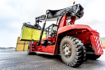 Reach-Stacker carrying a yellow container