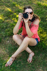 Girl with Camera taking a picture - lifestyle