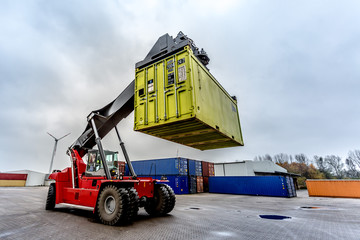 Reach-Stacker carrying a yellow container