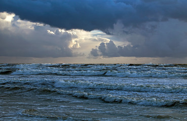 Beautiful evening clouds over the storming Bali Sea