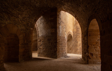 Fototapeta na wymiar Wonderful sun rays in ond stone walls in Castello Maniace, Siracusa, Italy