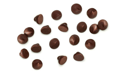 Scattered chocolate chips morsels or drops from top view isolated on white background