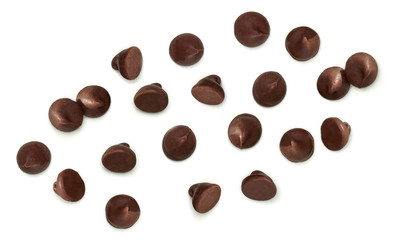 Scattered chocolate chips morsels or drops from top view isolated on white background