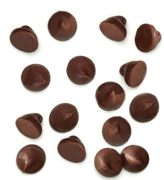 Scattered chocolate chips morsels or drops from top view isolated on white background