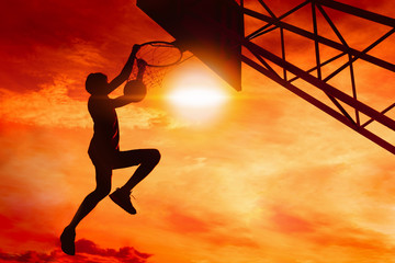 Basketball player performs a slam dunk © sutadimages