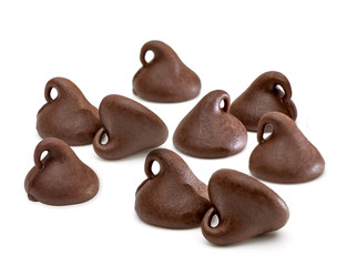 Scattered chocolate chips morsels or drops isolated on white background