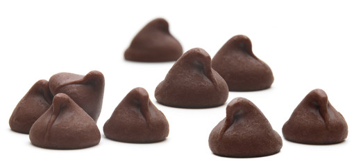 Scattered chocolate chips morsels pile from top view isolated on white background