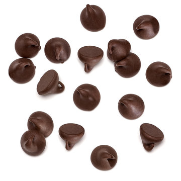 Scattered chocolate chips morsels or drops pile from top view isolated on white background