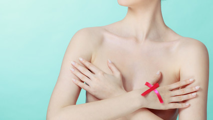 Fototapeta premium Naked woman with breast cancer awareness ribbon