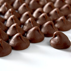 Chocolate drops or chocolate chips from top view isolated on white background