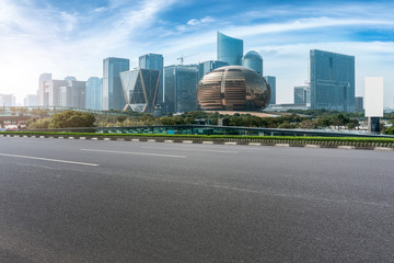 Fototapeta na wymiar Urban road asphalt pavement and skyline of Hangzhou urban construction