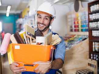 Master with tools in hands with purchases in store