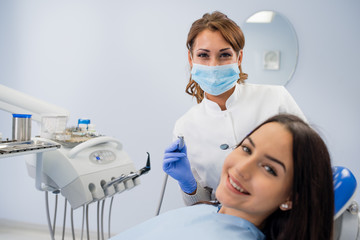 Happy girl smiling at the dentist