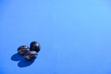 Plums on blue background