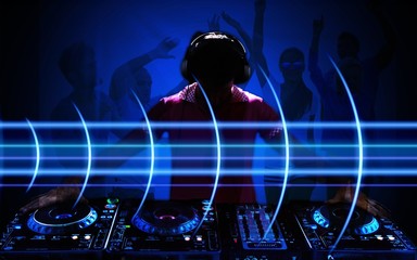 Portrait of confident young DJ with headphones on head mixing