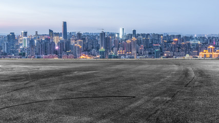 cityscape and skyline of downtown near water of chongqing at night