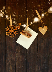 christmas card with gingerbread,Pimpernel with fir and fir-cone ,empty blank ,hanging on wooden background/ Christmas handmade garland