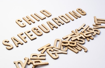 Child safeguarding concept, word spelled out in wooden letters