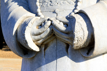 stone carving characters hands