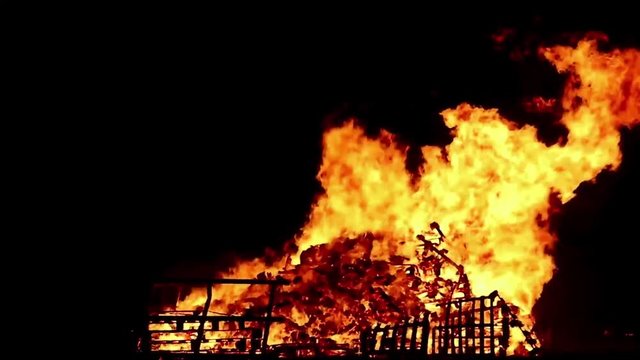 Bonfire at night with wild flames