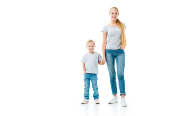 Mom and son holding hands and looking at camera isolated on white