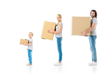 Fototapeta na wymiar Happy family holding boxes and looking at camera isolated on white