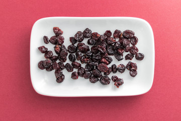 Cranberries on rectangular white plate with rounded corners.