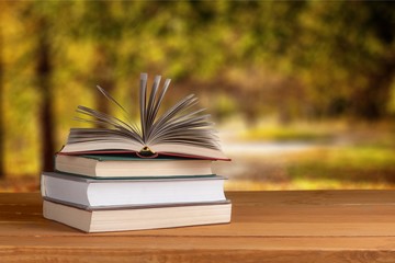 Old stacked books on wooden table
