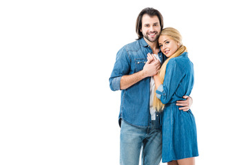 Lovely couple in jeans holding hands and hugging isolated on white