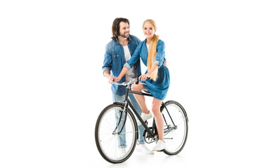 Fototapeta na wymiar Blonde girl riding bicycle and man helping her isolated on white