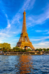 Paris Eiffel Tower and river Seine at sunset in Paris, France. Eiffel Tower is one of the most iconic landmarks of Paris