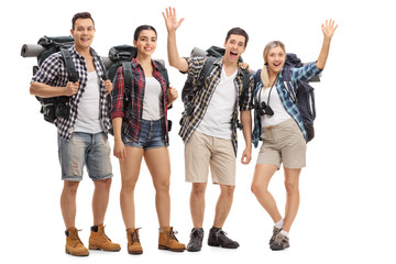 Group of cheerful hikers with backpacks