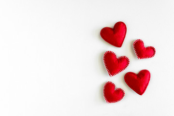 Present box with felt love hearts on white wooden background. Valentine's day celebration concept. Top view. Flat lay.