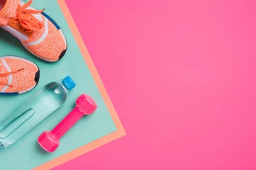 Poster Flat lay with sport equipment on pink background © LIGHTFIELD STUDIOS