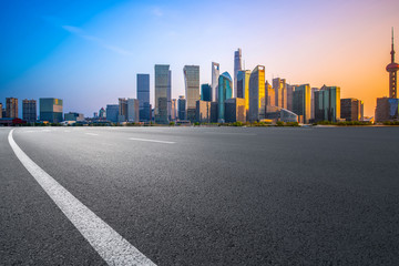 Empty asphalt road along modern commercial buildings in China's cities