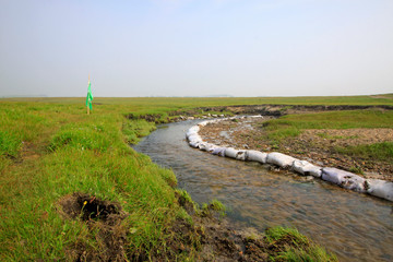 Fototapeta premium small river in the WuLanBuTong grassland, China