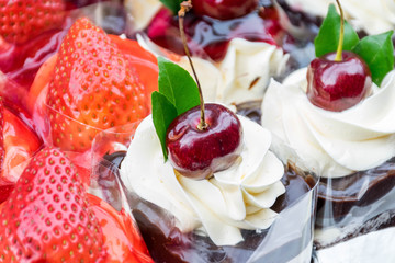 Cheese cakes with strawberry on top and Cheese cakes with cherry on top
