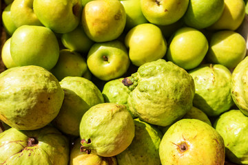 Fresh Organic green and ripe guava and apples background