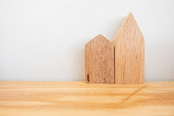 Two shape of wooden on table over white wall background