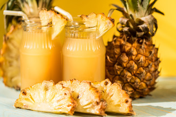 Pineapple juice and slice placed on a wooden table
