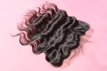 Body wavy black human hair weaves extensions lace frontal upon pink background