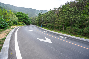 empty asphalt road with city skyline