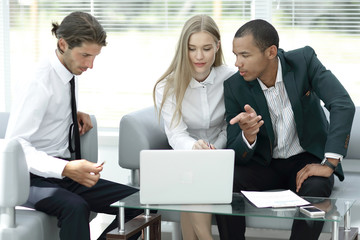 business team discussing information with a laptop