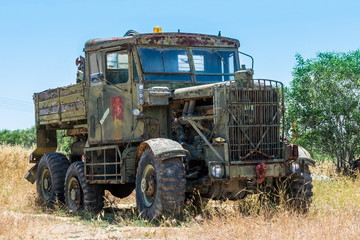 Old green truck on blue sky background