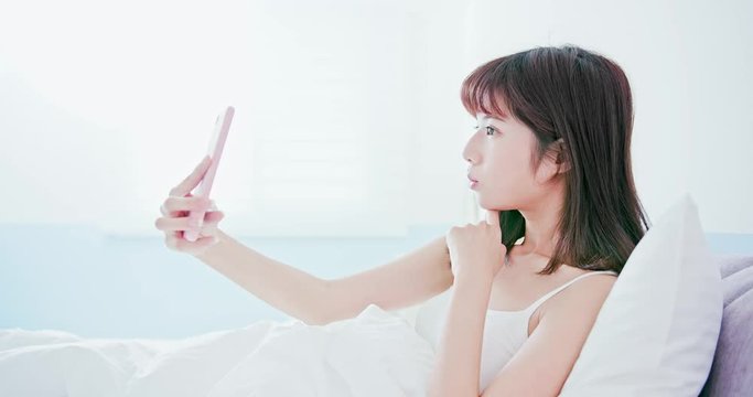 woman take selfie in bed