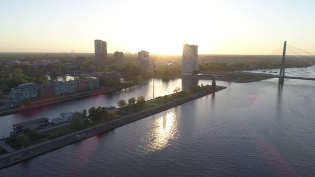 Aerial drone fly-by shot of a large flag of Latvia during sunset in Riga, capital of Latvia.