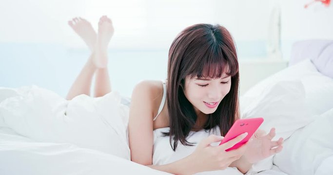 woman use phone in bed