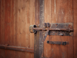 rusty padlock on wooden door