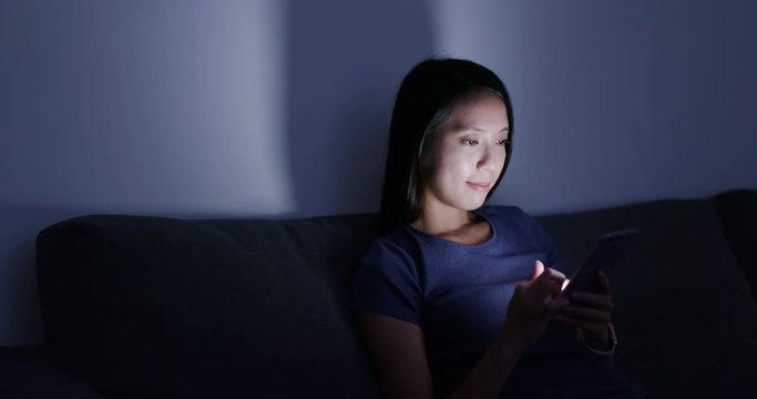Woman use of smart phone at home in the evening