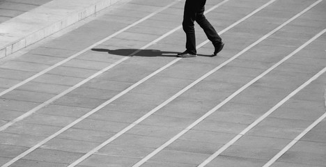 Fototapeta na wymiar man walking on the street in urban - monochrome
